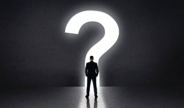 istock Man standing in front of big question of life 1165263823