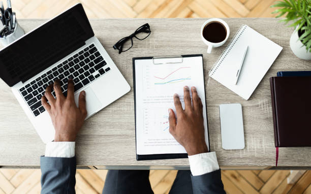 istock Black businessman working on his laptop sitting on workplace 1165263868