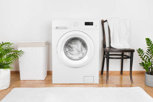 istock Interior of laundry room with washing machine and laundry basket 1165264496