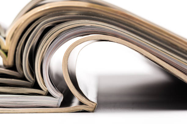 istock selective focus of the stacking magazine place on white background. Colorful abstract background 1165264692