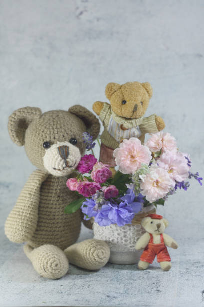 istock Teddy bear foll with flower bouquet. 1165264973