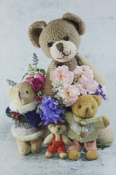 istock Teddy bear foll with flower bouquet. 1165264981