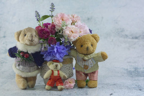 istock Teddy bear foll with flower bouquet. 1165265014