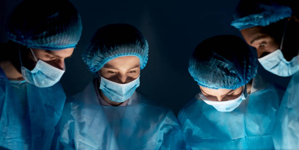 istock Team of surgeons performing operation in hospital 1165265819