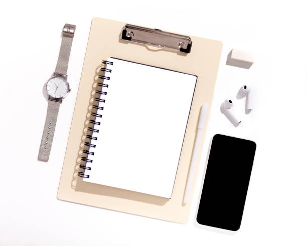 istock Cellphone with black blank screen on Office table with supplies 1165266513