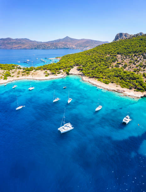 the sea of moni at aegina island with sailing boats and people - beautiful blue sport vertical imagens e fotografias de stock