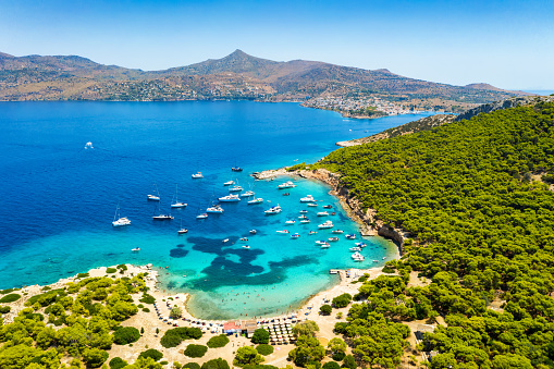 Aerial view to the beautiful beach of Moni island, next to the village Perdika on Aegina island with turquoise sea, Saronic Gulf, Greece