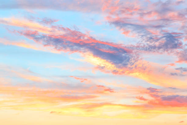 istock Heavenly abstract summer gentle background. Beautiful picturesque bright majestic dramatic evening morning sky at sunset or dawn in orange and blue in pastel colors. The sun rises on a warm day 1165268113