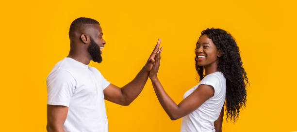 istock Cheerful man and woman giving each other high five 1165268155