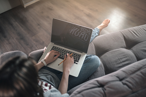 Woman uses laptop with at home. Template for your Mockup.