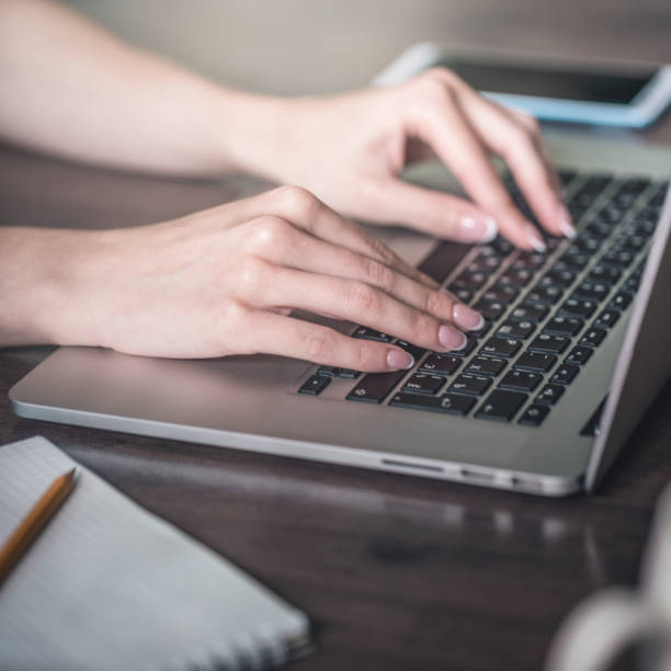 istock Woman uses laptop at work 1165270227