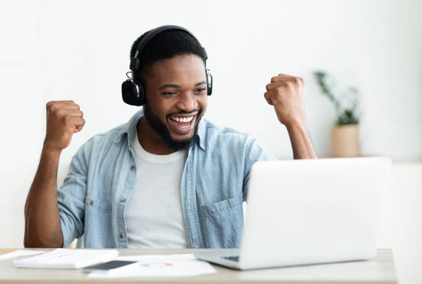 istock African American male freelancer celebrating completing the project 1165270680