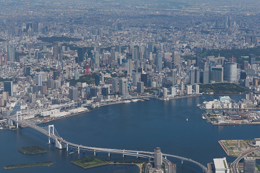 High angle view of Tokyo Bay and urban skyline against clear sky.