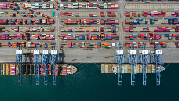istock Aerial view cargo ship terminal, Unloading crane of cargo ship terminal, Aerial view industrial port with containers and container ship. 1165277859
