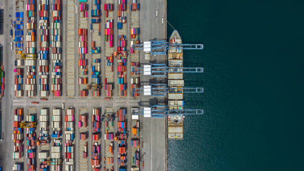 istock Aerial view cargo ship terminal, Unloading crane of cargo ship terminal, Aerial view industrial port with containers and container ship. 1165277907