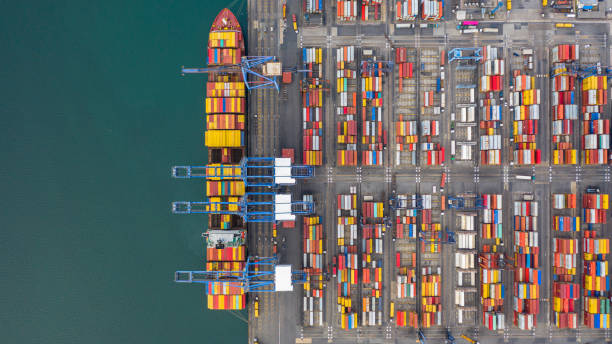 istock Aerial view cargo ship terminal, Unloading crane of cargo ship terminal, Aerial view industrial port with containers and container ship. 1165277912