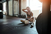 Young fit woman exercise with kettle ball getting tired