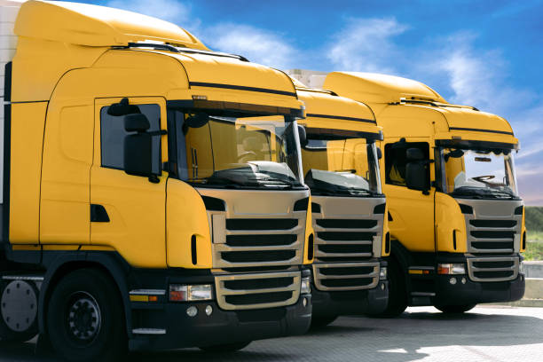 istock three yellow trucks of a transporting company 1165281091