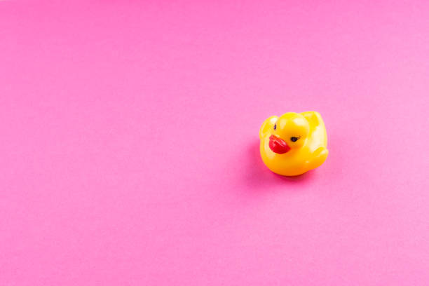 istock Yellow glamour rubber duck on pink background 1165286023