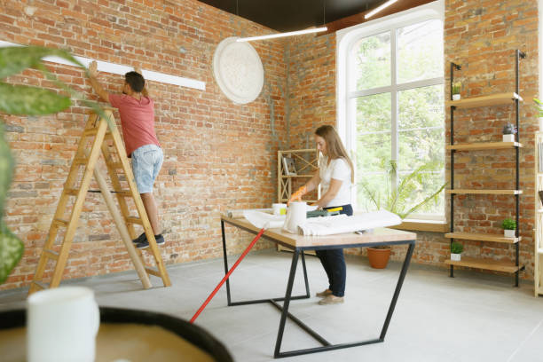 istock Young couple doing apartment repair together themselves 1165288880