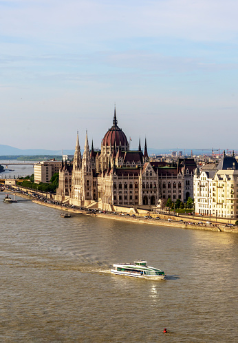 Danube river in Budapest with the historic building in the background in a sunny day