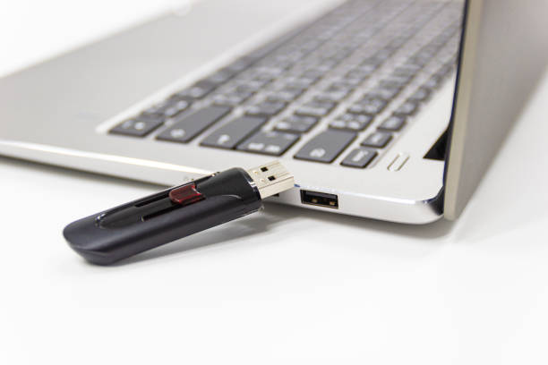 istock flash drive with laptop computer for conncet to USB port plug-in Laptop 1165290267