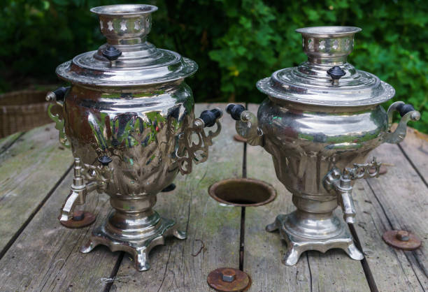 istock Two old metal samovar for making tea on a wooden table. 1165291115