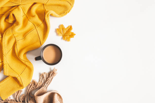 istock Autumn composition. Cup of coffee, yellow sweater, plaid on white background. Autumn, fall concept. Flat lay, top view, copy space 1165291323