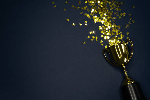 istock gold winning cup on dark blue background , success concept 1165291329