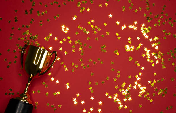 istock gold winning cup on red background , success concept 1165291503
