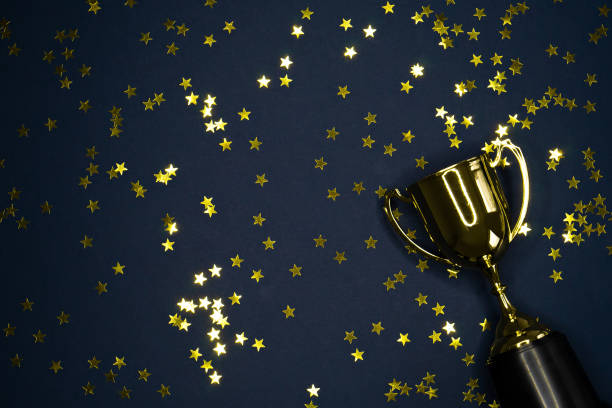 istock gold winning cup on dark blue background , success concept 1165291664