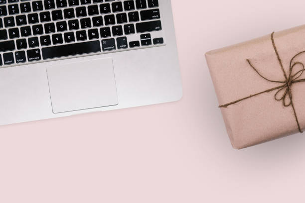 istock Computer and packaged parcel. Workplace employee engaged in logistics and sales of goods. E-commerce and package delivery concept. Online shopping 1165292887