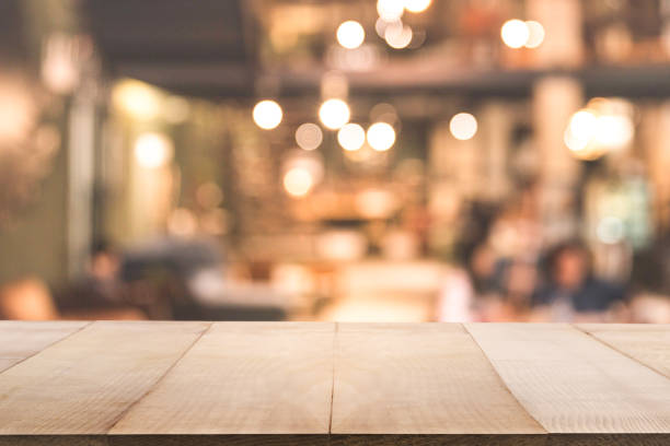 istock Blur background of coffee shop or restaurant interior background with empty wood table. 1165293101