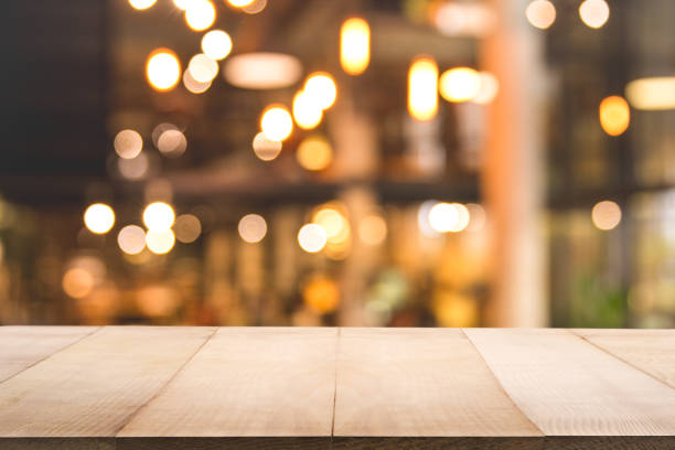 istock Blur background of coffee shop or restaurant interior background with empty wood table. 1165293128