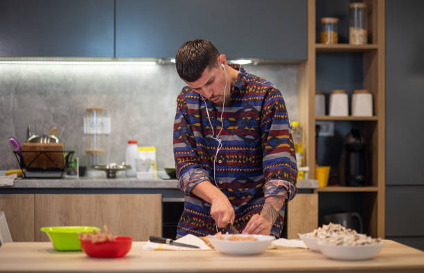 istock Cheerful dancing man preparing lunch at home 1165293316