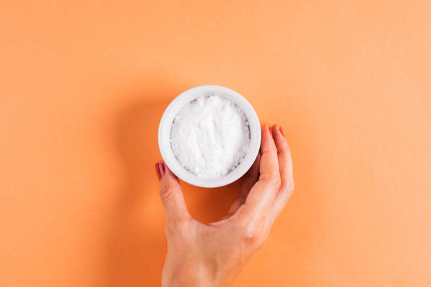 istock Baking soda in bowl on orange 1165293397