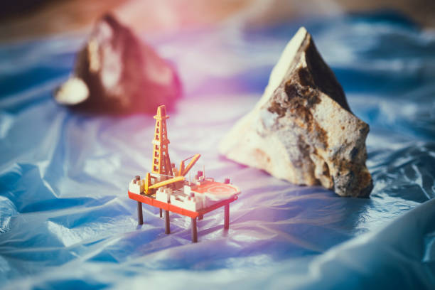 Arctic Icebergs with Oil and Gas Drilling platform Tabletop shot with homemade model of a drilling platform and two flints diorama photos stock pictures, royalty-free photos & images