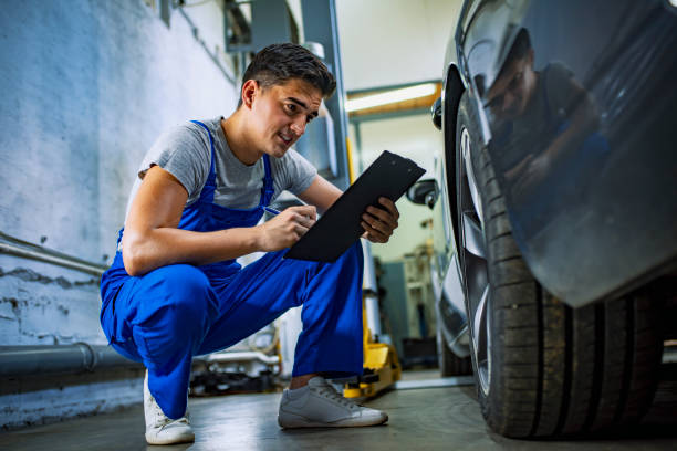 istock Men checking car wheel in auto service garage 1165308935