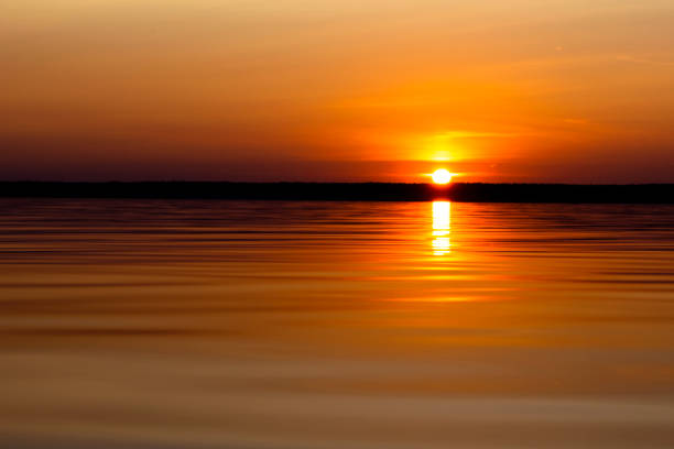 istock Sunset sky background. Dramatic gold sunset sky with evening sky clouds over the sea. Stunning sky clouds in the sunrise. Sky landscape. Panoramic sky view. 1165313409