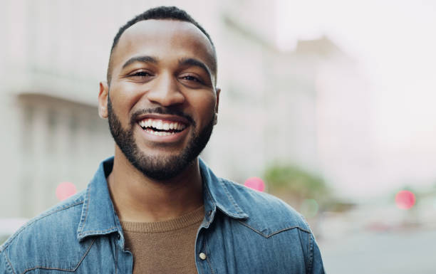 Living that urban life Portrait of a handsome young man in the city smiling stock pictures, royalty-free photos & images