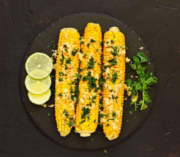istock Boiled corn with mexican spices, butter, cilantro. 1165316070