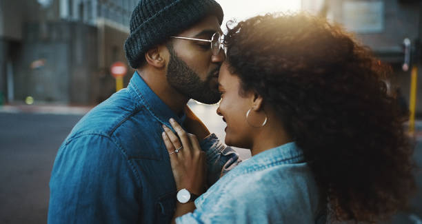 It's always the right time for romance Shot of a young couple sharing a romantic moment in the city kissing photos stock pictures, royalty-free photos & images