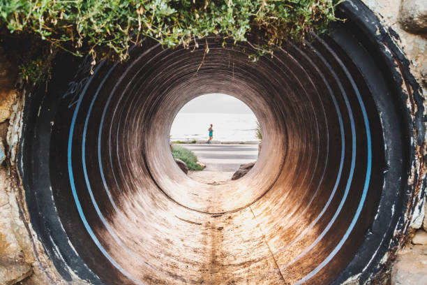 istock Old large pipe tunnel by the coast 1165318826