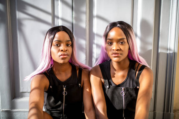 Portrait of a twin sisters looking at camera