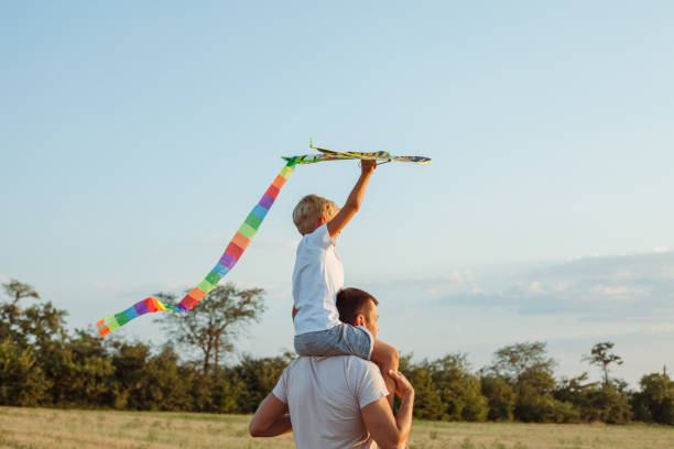 istock Father and son flying a kite on the hill 1165320688