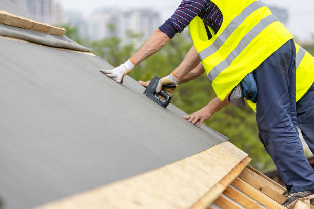 Building construction process of new wooden roof on wood frame house Man working with stapler and special waterproof bitumen membrane. Mature and professional contractor in protective uniform wear standing on roof top of new modern building construction stapled paper stock pictures, royalty-free photos & images