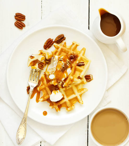 istock Homemade waffles with caramel and pecans. 1165324873