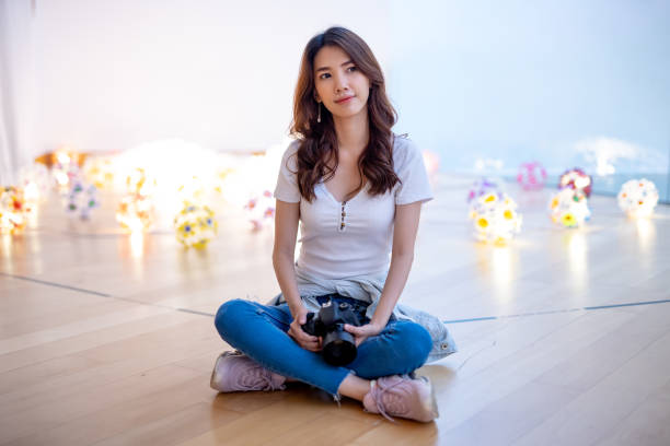 istock Beautiful girl and light bulb backdrop 1165324879