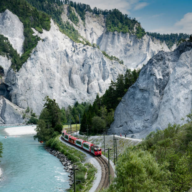 hikers and the Rhaetian railway on the banks of the Rhine River in the Ruinaulta Gorge Versam, GR / Switzerland - 30. July 2019: hikers and the Rhaetian railway on the banks of the Rhine River in the Ruinaulta Gorge in the Swiss Alps graubunden canton stock pictures, royalty-free photos & images