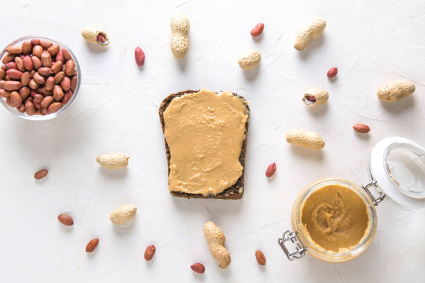 istock Whole grain bread with walnut paste with peanuts. Food vegan concept. Flat lay. View from above. 1165325223